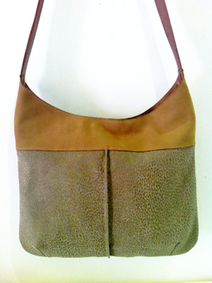 A coffe latte color leather bag combined with dark cream leather with gold leopard print.